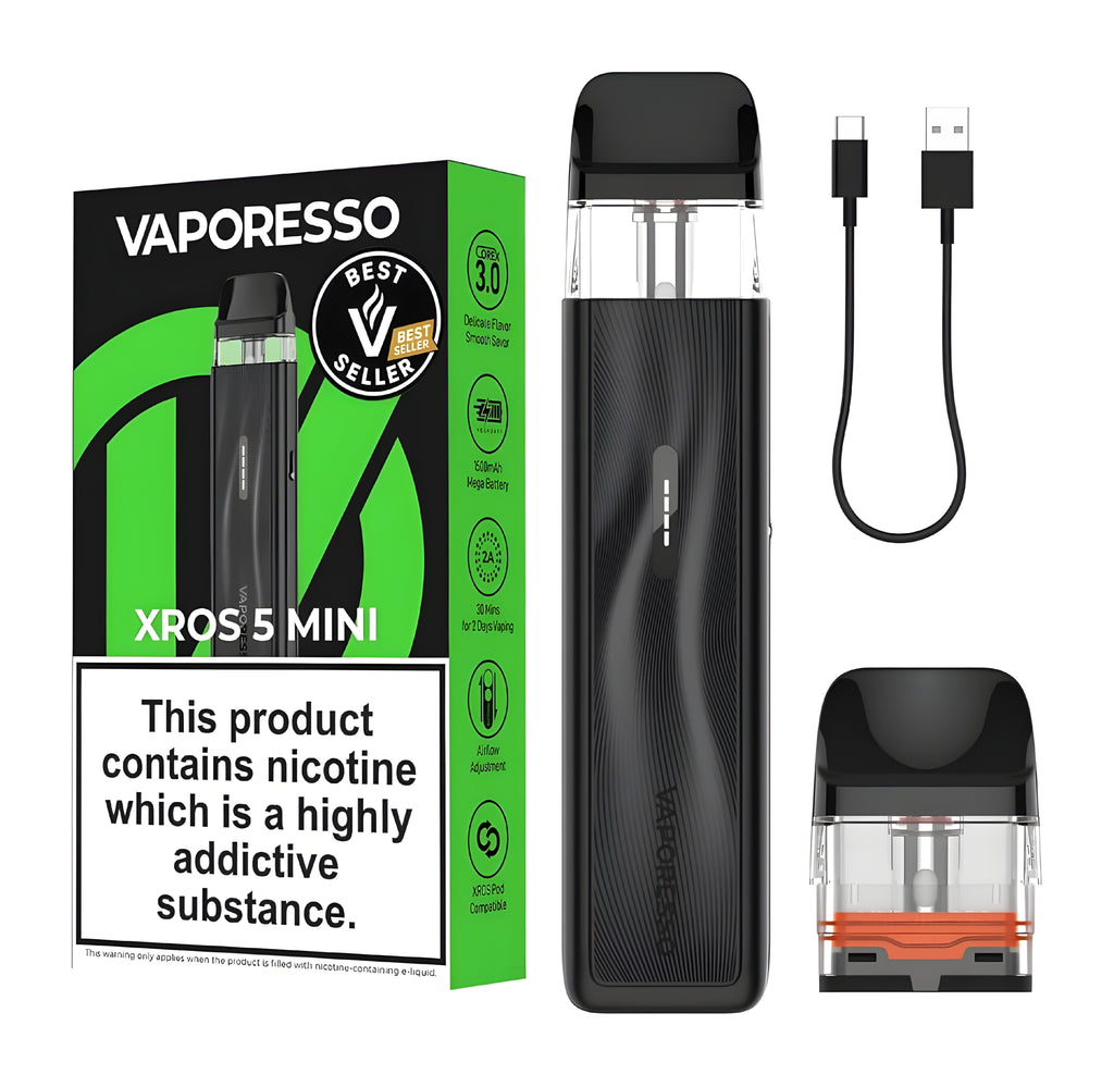 Vaporesso Xros 5 Mini vape device in black, shown with its green and black retail box, a black USB charging cable, and a replacement coil cartridge with an orange accent, all on a white background.